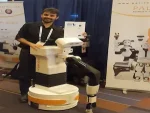 Jordi Pagès of PAL Robotics standing with TIAGo robot at IROS 2017