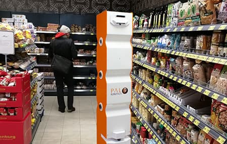 The retail robot StockBot taking stocks and inventory in the aisle of a supermarket