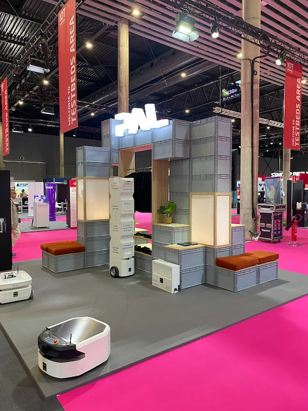 PAL Robotics' testbed and booth at the IOT Solutions World Congress 2024 in Barcelona with the RFID inventory solution StockBot, the omnidirectional AMR TIAGo OMNI Base and the mobile base ARan.