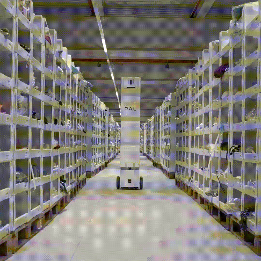 StockBot scanning open shelves in an aisle at TENDAm warehouse